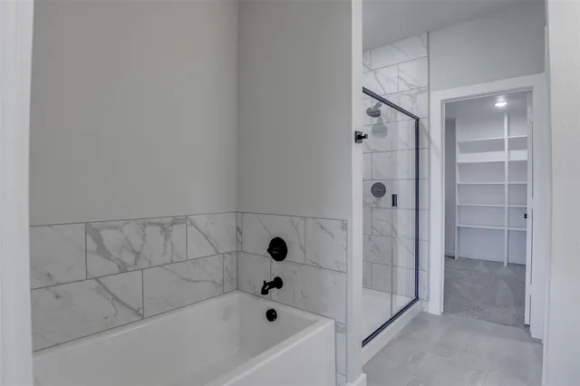 a bathroom with a bathtub and shower