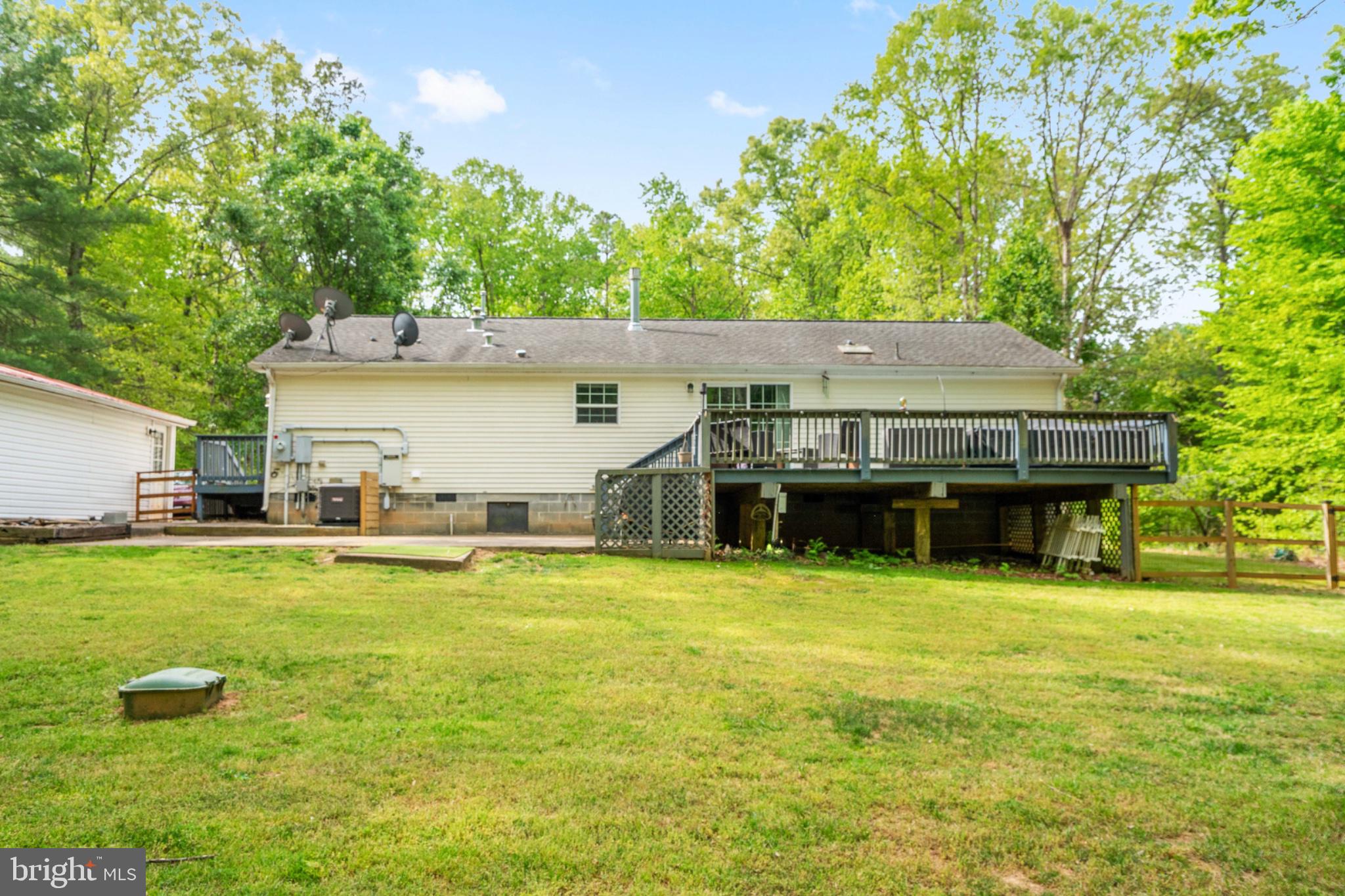 2319 Sizer Road Beaverdam, VA 23015 - Photo 47 of 61 a view of a patio with table and chairs under an umbrella