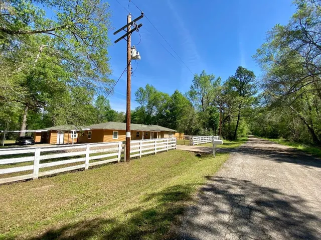 a view of a swimming pool with an outdoor seating and a yard