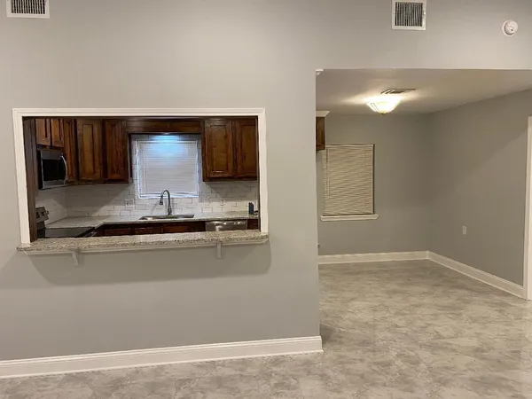 a view of an empty room with a fan