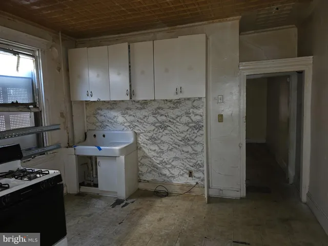 a kitchen with a stove and a refrigerator
