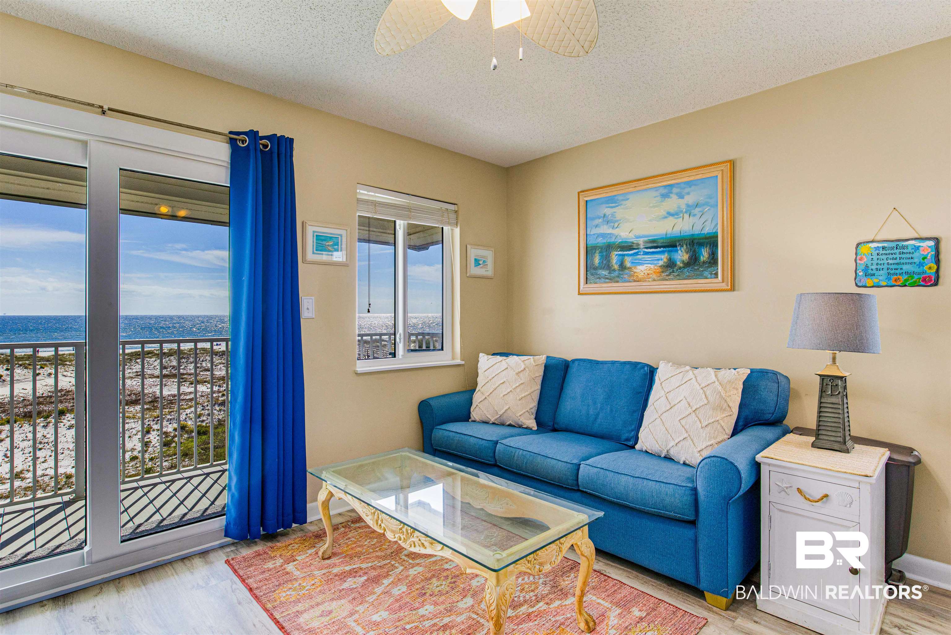 400 Plantation Road, Unit 1303 Gulf Shores, AL 36542 - Photo 3 of 24 Living room featuring Gulf front water view, ceiling fan, vinyl flooring & new doors/windows