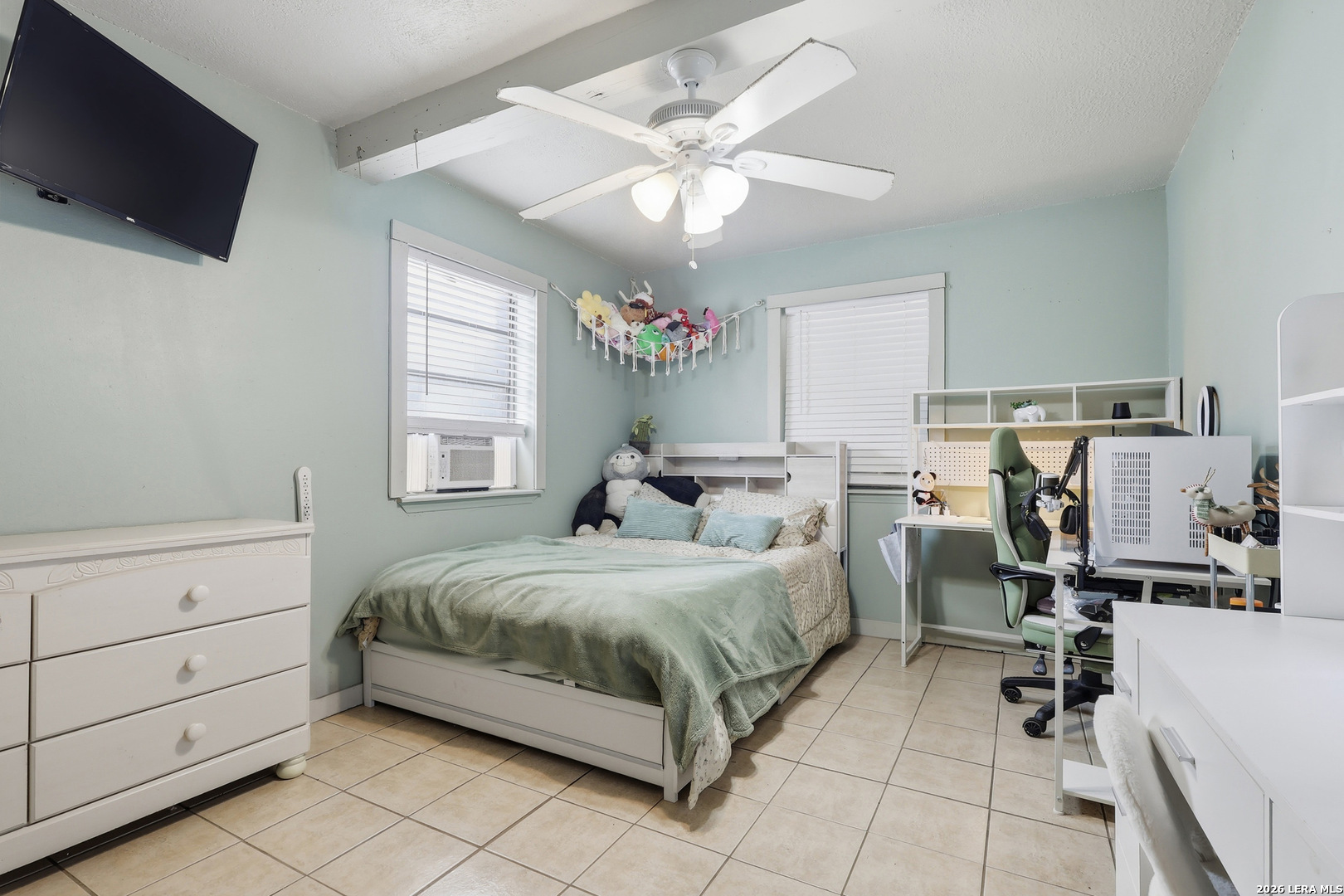 31910 Blanco Road Bulverde, TX 78163 - Photo 12 of 25 a bedroom with a bed and flat screen tv