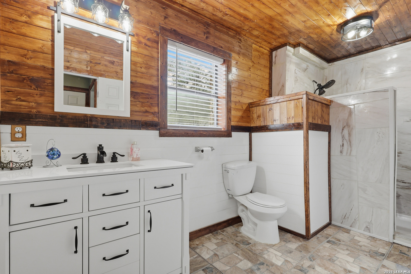 31910 Blanco Road Bulverde, TX 78163 - Photo 13 of 25 a bathroom with a toilet sink and mirror
