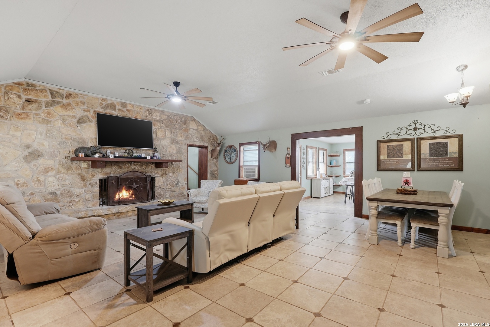 31910 Blanco Road Bulverde, TX 78163 - Photo 5 of 25 a living room with furniture a fireplace and a flat screen tv