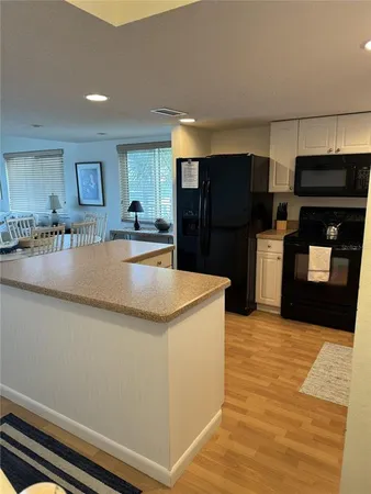 a kitchen with stainless steel appliances granite countertop a refrigerator and a stove