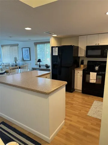 a kitchen with stainless steel appliances granite countertop a refrigerator and a stove