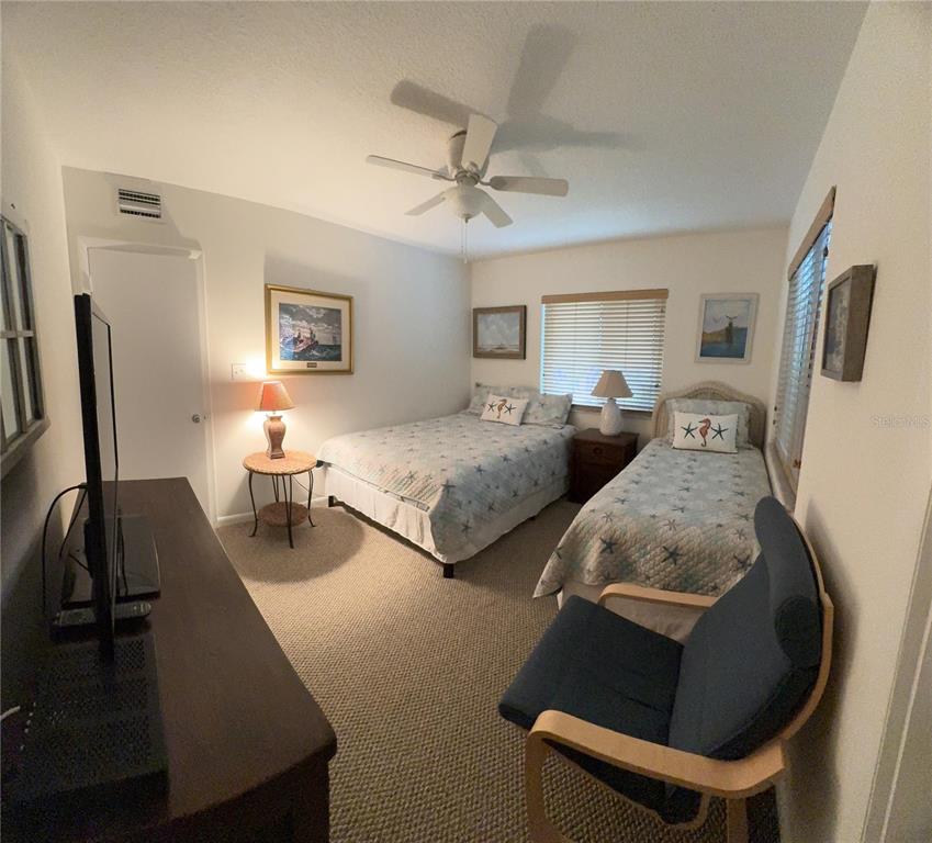 815 Ocean Shore Boulevard, Unit 13A Ormond Beach, FL 32176 - Photo 6 of 11 a bedroom with two beds and a flat screen tv