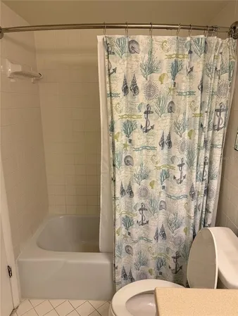 a bathroom with a shower curtain and a toilet