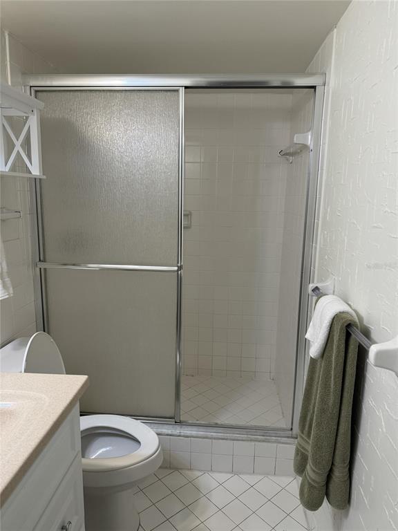 815 Ocean Shore Boulevard, Unit 13A Ormond Beach, FL 32176 - Photo 9 of 11 a bathroom with a shower and a toilet