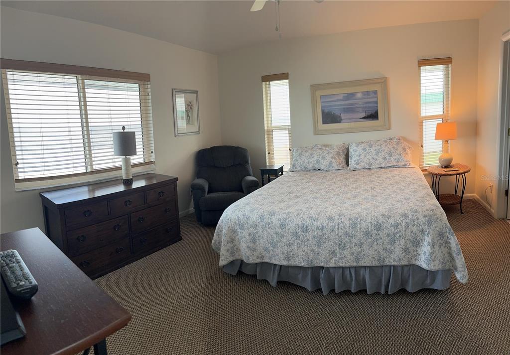 815 Ocean Shore Boulevard, Unit 13A Ormond Beach, FL 32176 - Photo 10 of 11 a bedroom with a bed and wooden floor