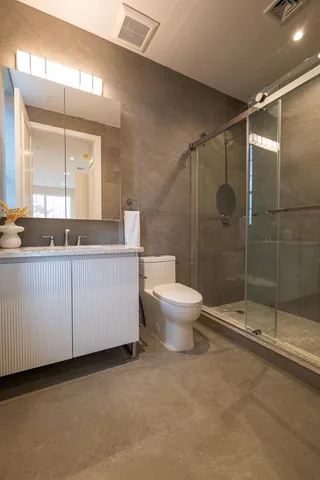 a bathroom with a shower sink and toilet