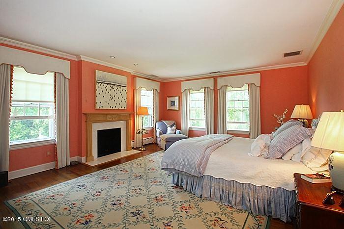25 Ridgeway Greenwich, CT 06831 - Photo 20 of 25 a bedroom with a bed and a fireplace