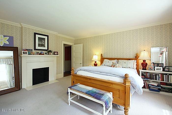 25 Ridgeway Greenwich, CT 06831 - Photo 25 of 25 a bed room with a bed and a fireplace