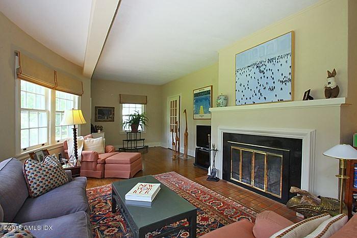25 Ridgeway Greenwich, CT 06831 - Photo 9 of 25 a living room with furniture a fireplace and a large window