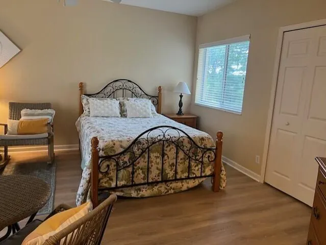 a bedroom with a bed window and a table in it