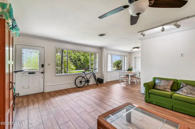 a living room with furniture and a wooden floor