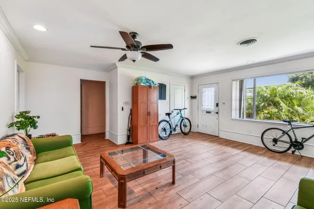 a view of a dining room with furniture window and wooden floor