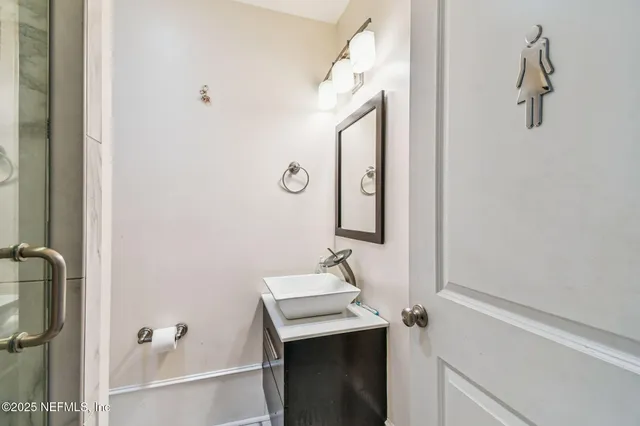 a bathroom with a toilet a sink and a mirror