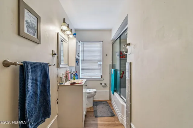 a kitchen with stainless steel appliances a sink cabinets and wooden floor