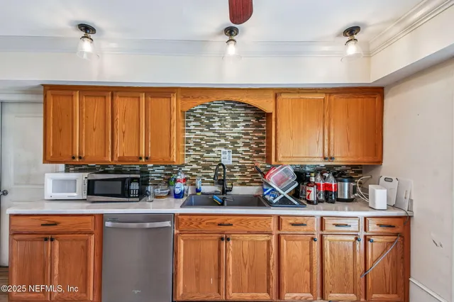 a kitchen with stainless steel appliances a refrigerator sink and cabinets