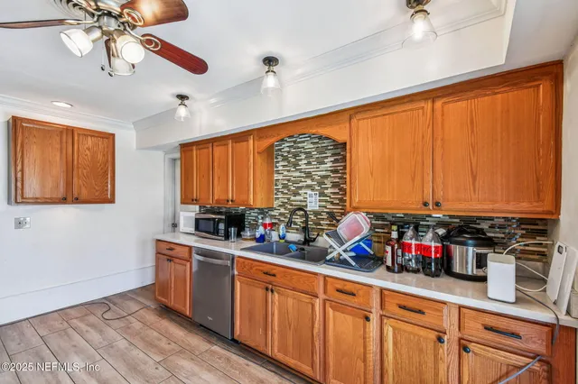 a kitchen with appliances a refrigerator and a stove top oven
