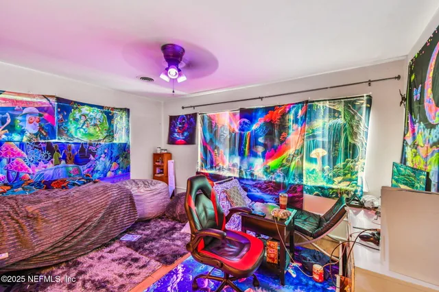 a view of house in front of a big yard with large trees