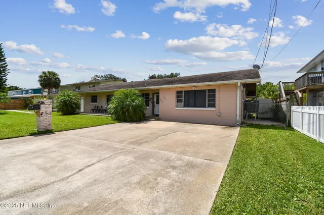 a view of house with yard and green space