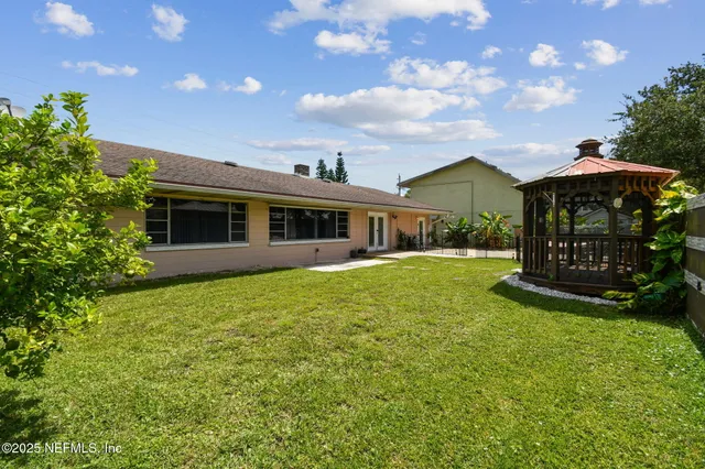 an aerial view of a house with a yard