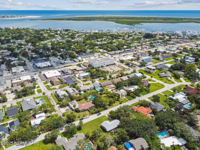 an aerial view of a house with garden space and lake view