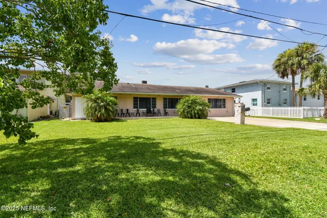 a bedroom with a bed a dresser and flat screen tv