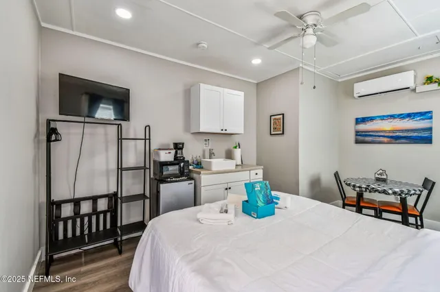 a view of a dining room with furniture a chandelier and wooden floor