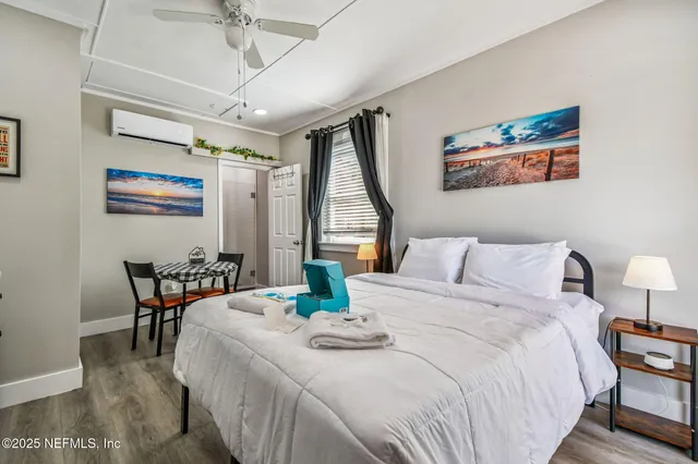 a bedroom with a bed and flat screen tv