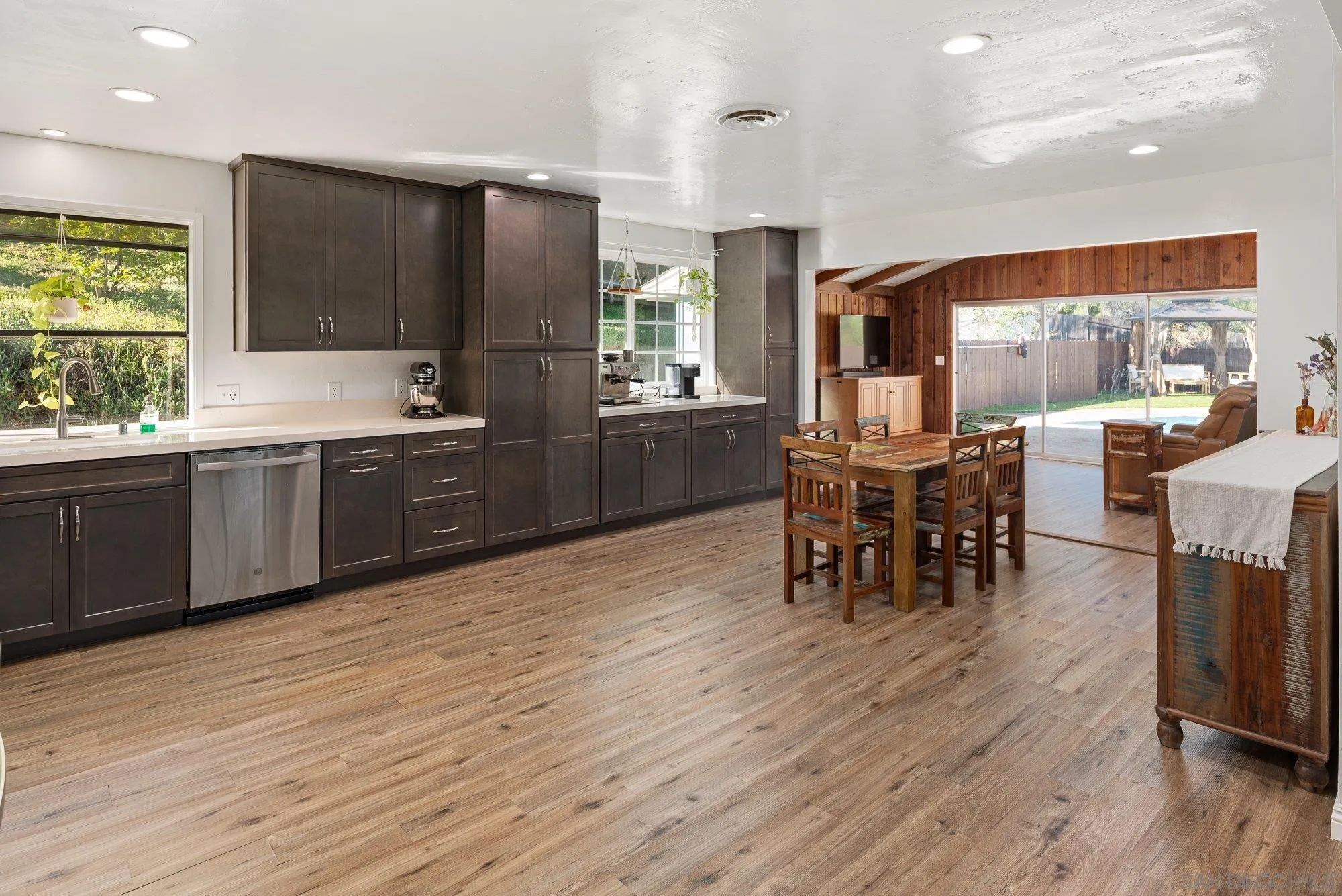 1780 Grove Road El Cajon, CA 92020 - Photo 17 of 59 a kitchen with stainless steel appliances granite countertop wooden floors and wooden cabinets