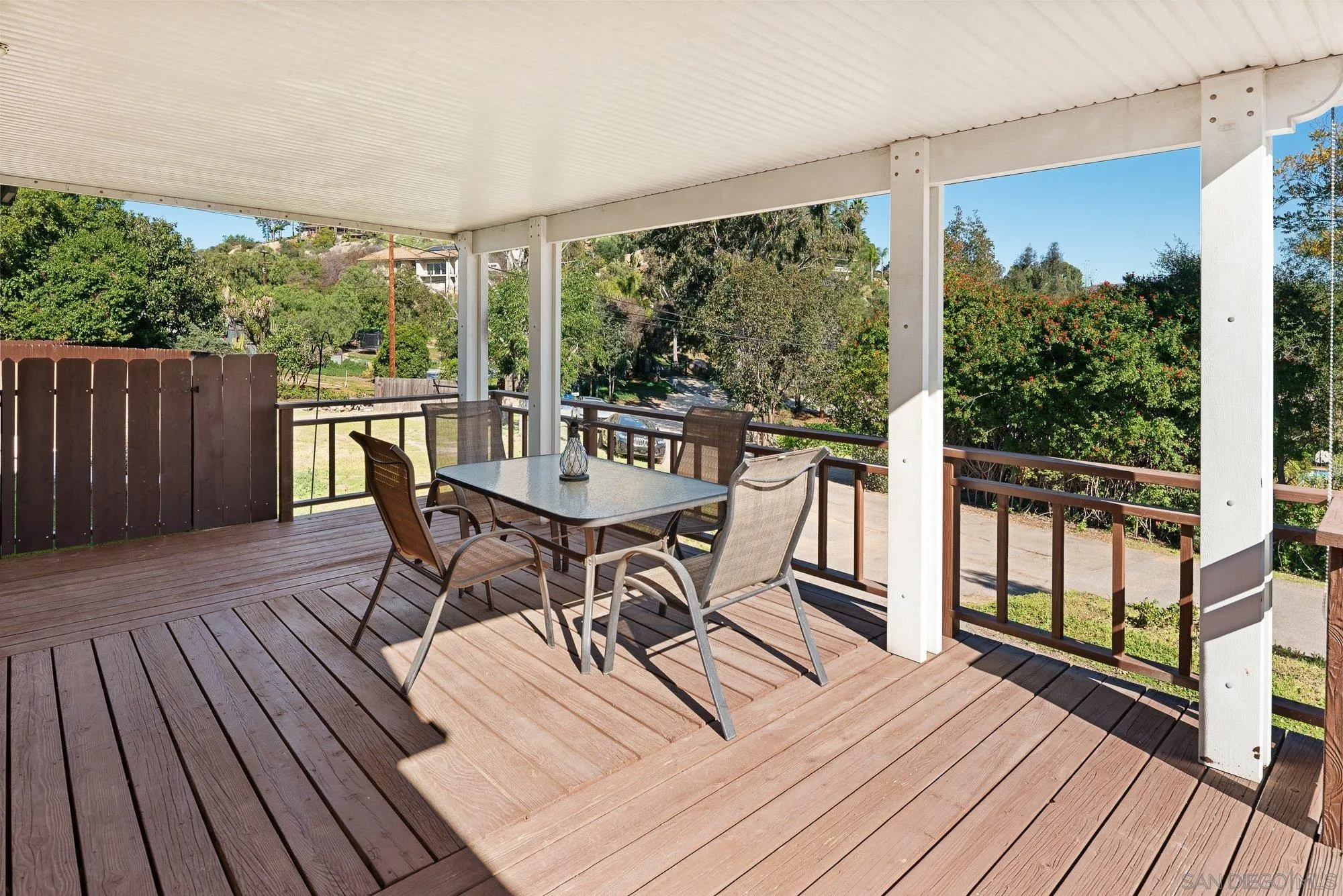 1780 Grove Road El Cajon, CA 92020 - Photo 3 of 59 a view of a roof deck with table and chairs floor to ceiling window with wooden floor