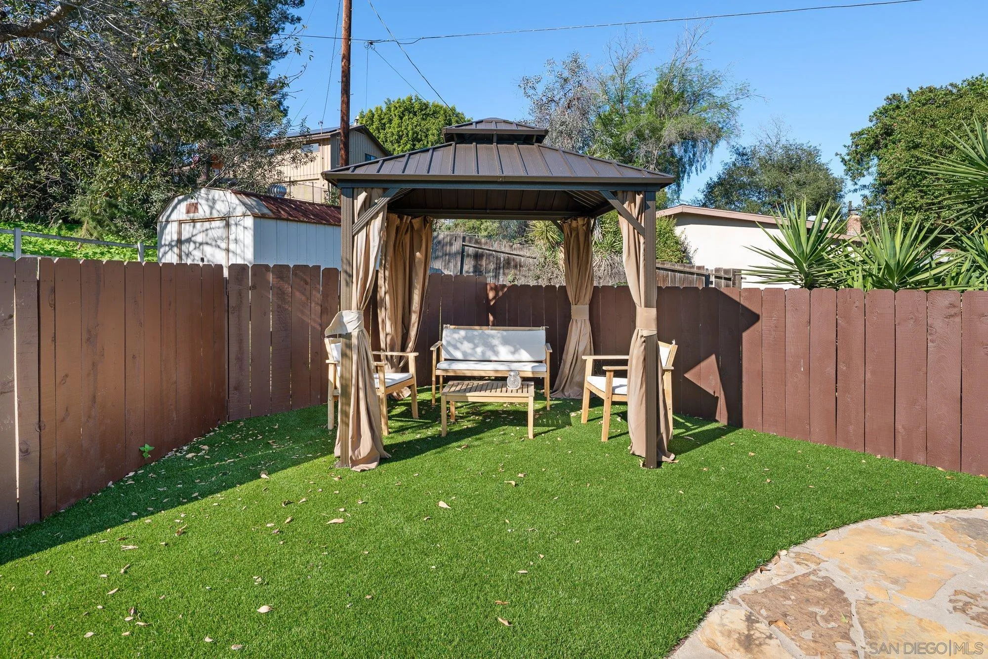 1780 Grove Road El Cajon, CA 92020 - Photo 35 of 59 a view of a chair and table in backyard with wooden fence