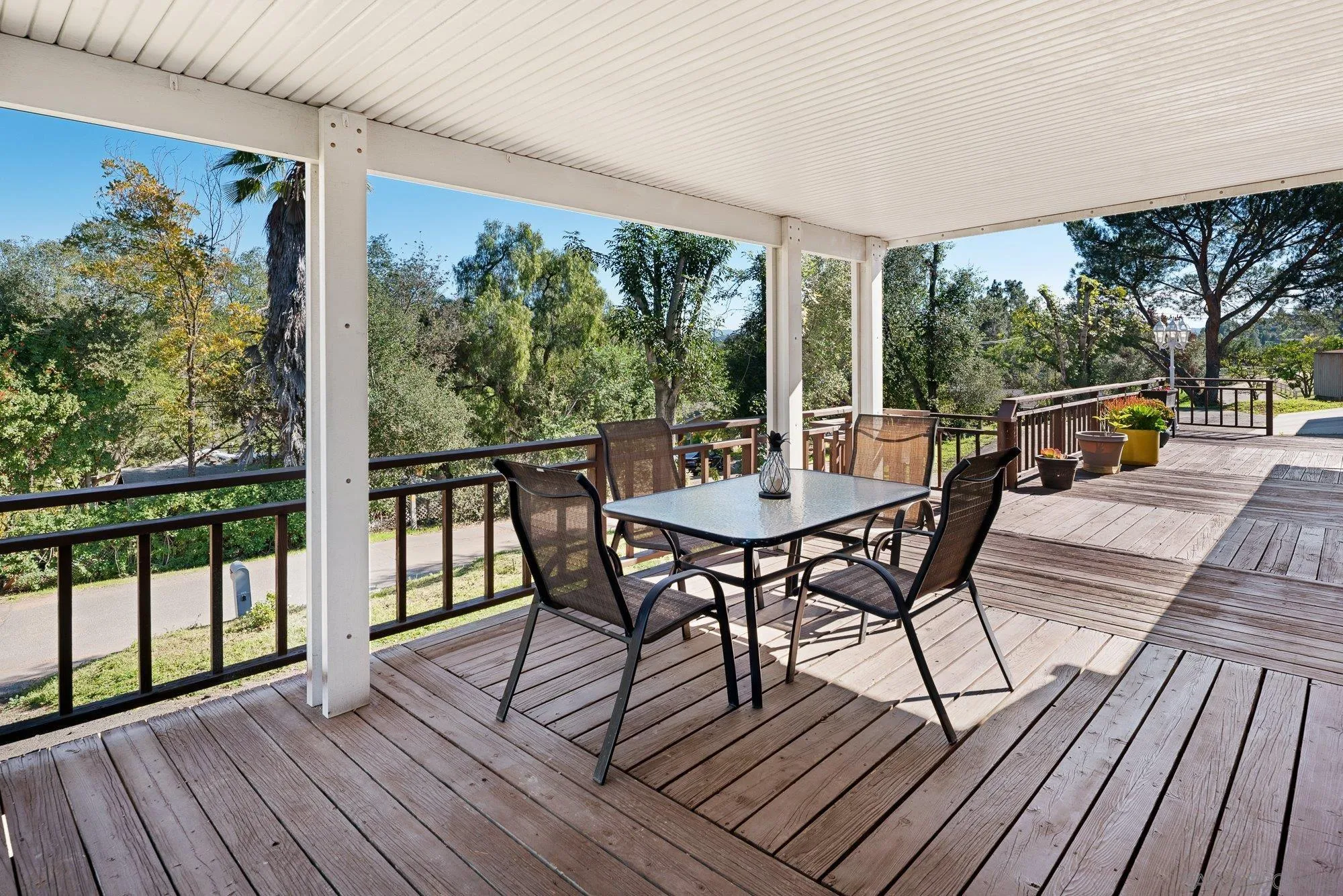 1780 Grove Road El Cajon, CA 92020 - Photo 4 of 59 a view of a patio with table and chairs with wooden floor and floor to ceiling window