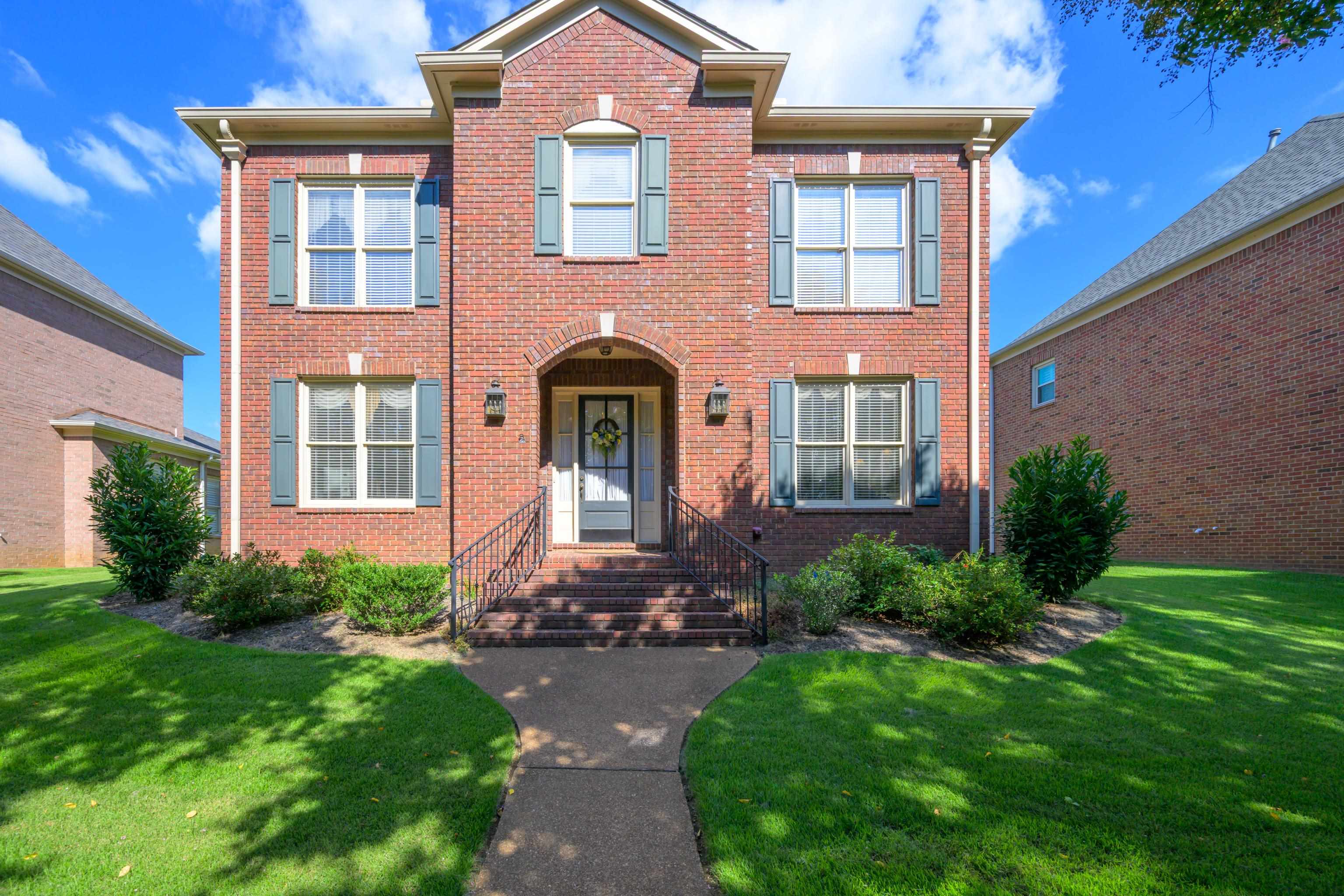 a front view of a house with garden