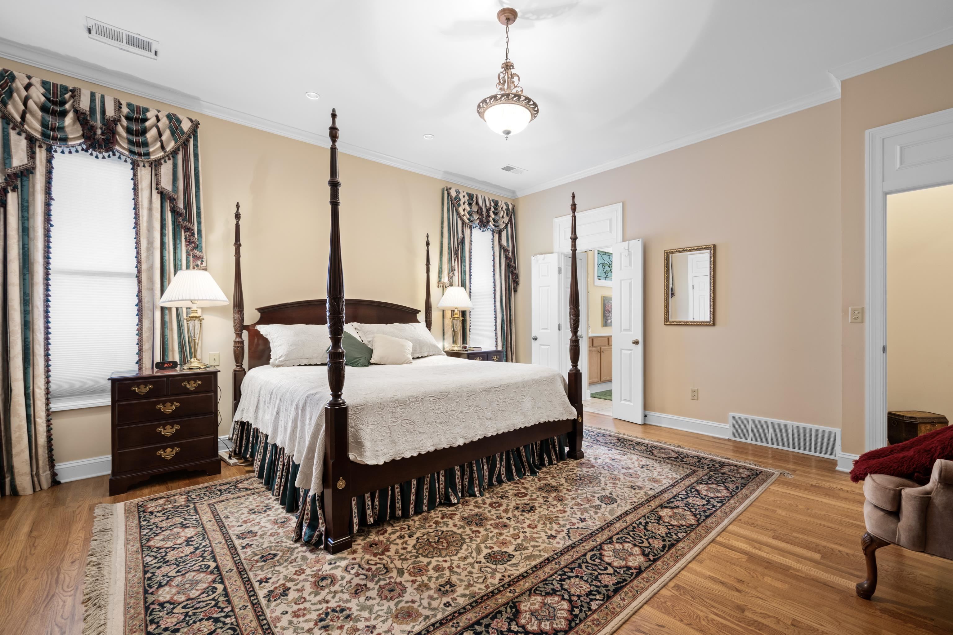 192 North White Station Road Memphis, TN 38117 - Photo 12 of 40 a bedroom with a bed a dresser and wooden floor