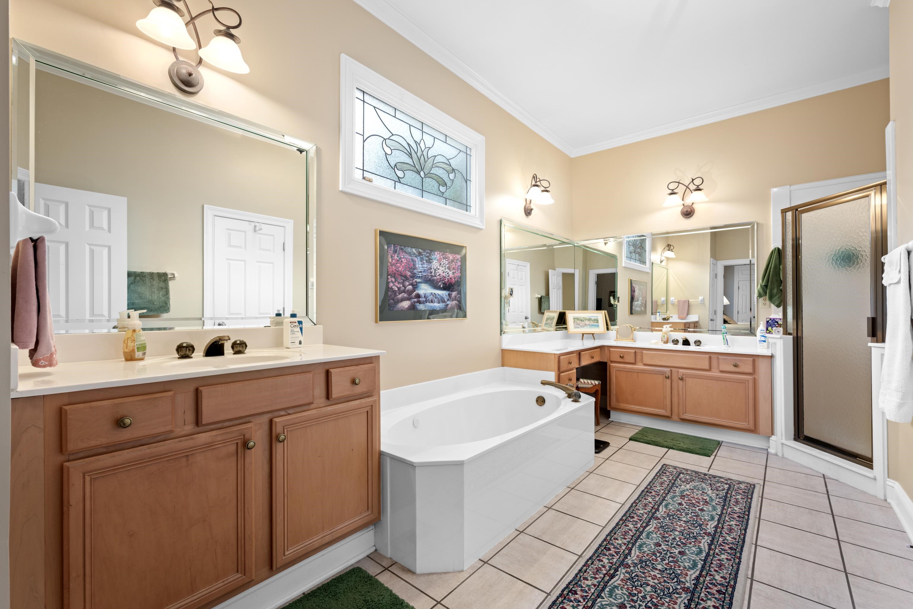 192 North White Station Road Memphis, TN 38117 - Photo 13 of 40 a large white kitchen with a refrigerator a sink dishwasher and white cabinets with wooden floor