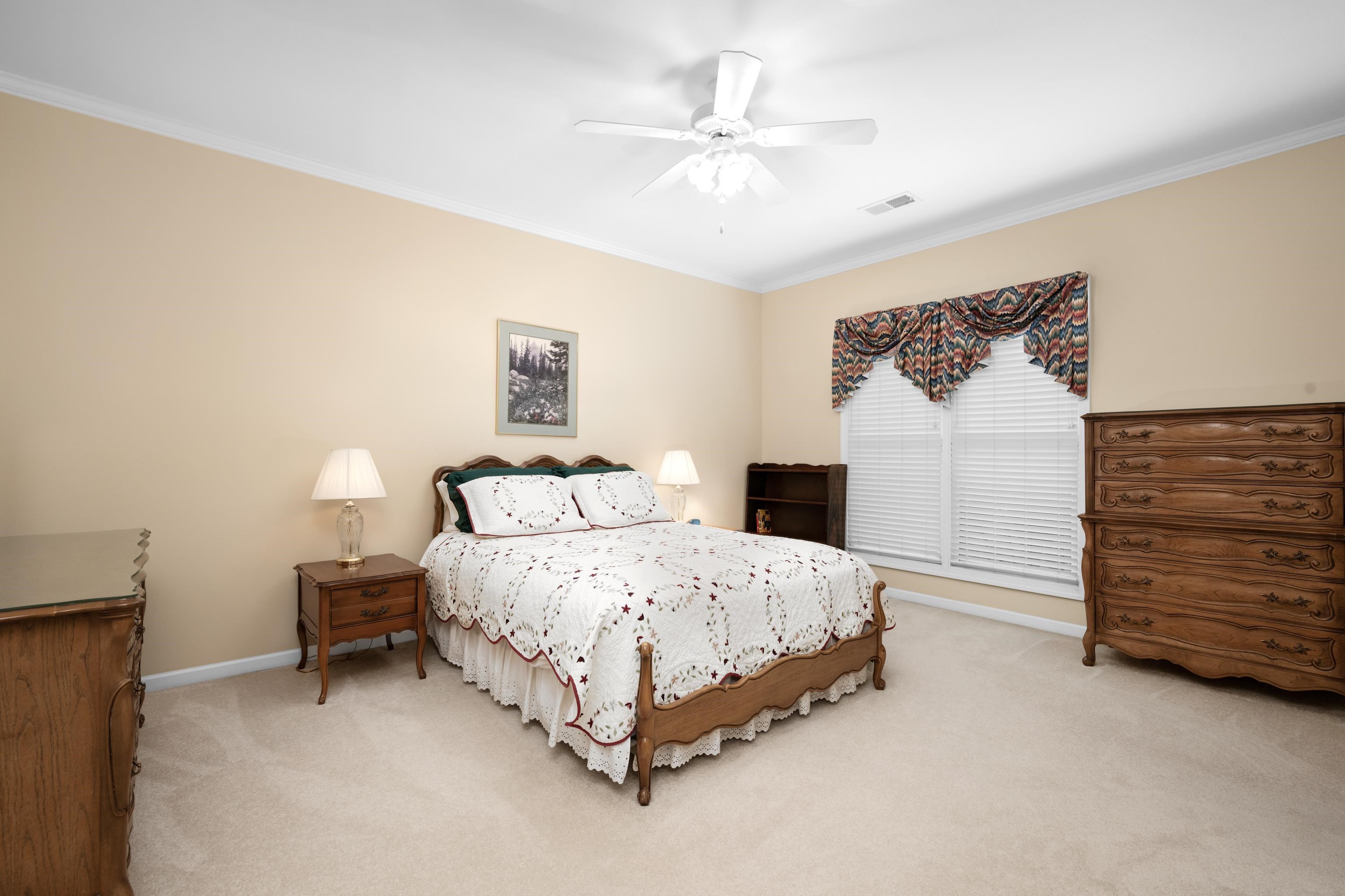 192 North White Station Road Memphis, TN 38117 - Photo 21 of 40 a bedroom with a bed and a chandelier
