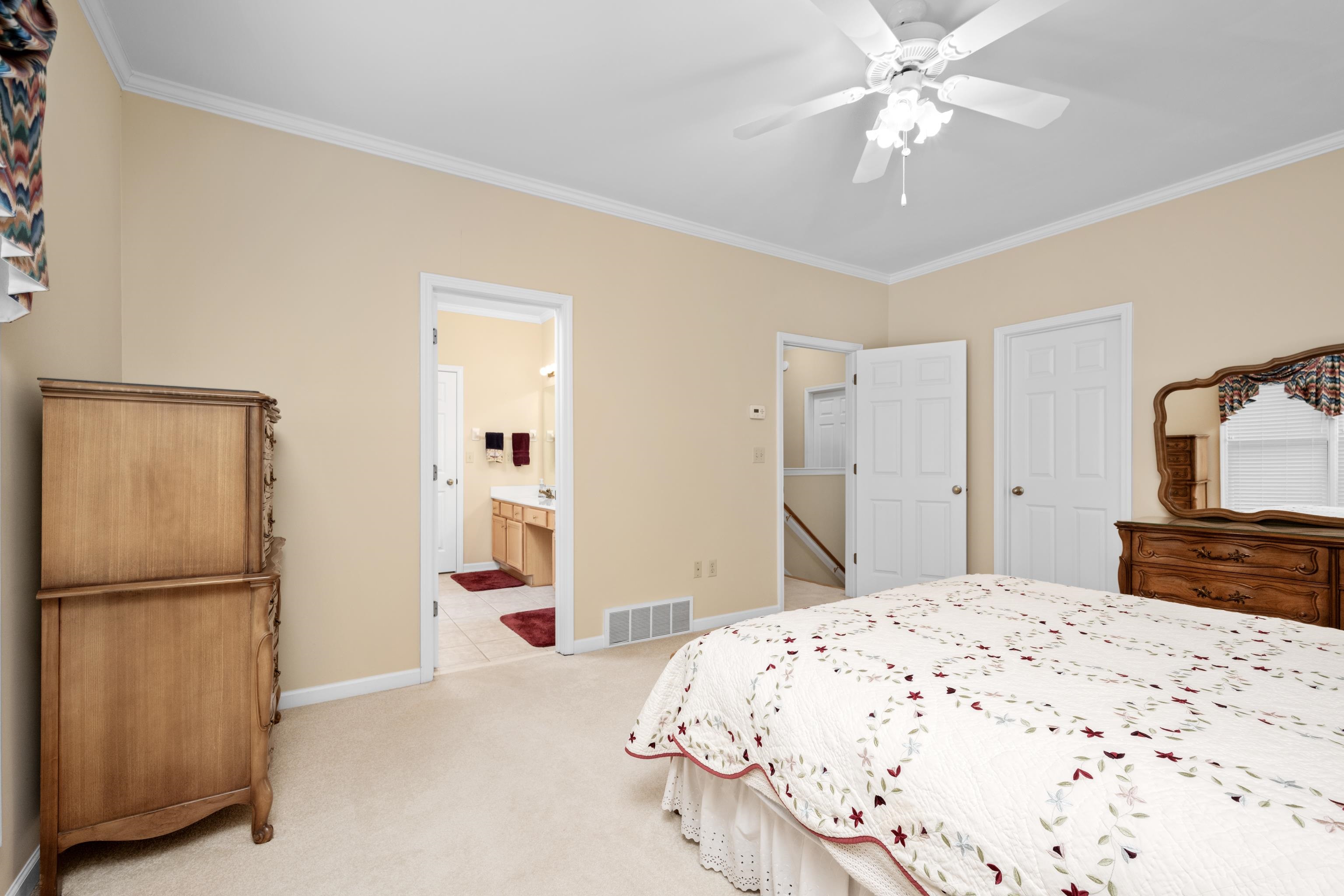 192 North White Station Road Memphis, TN 38117 - Photo 22 of 40 a bedroom with a large bed and a chandelier