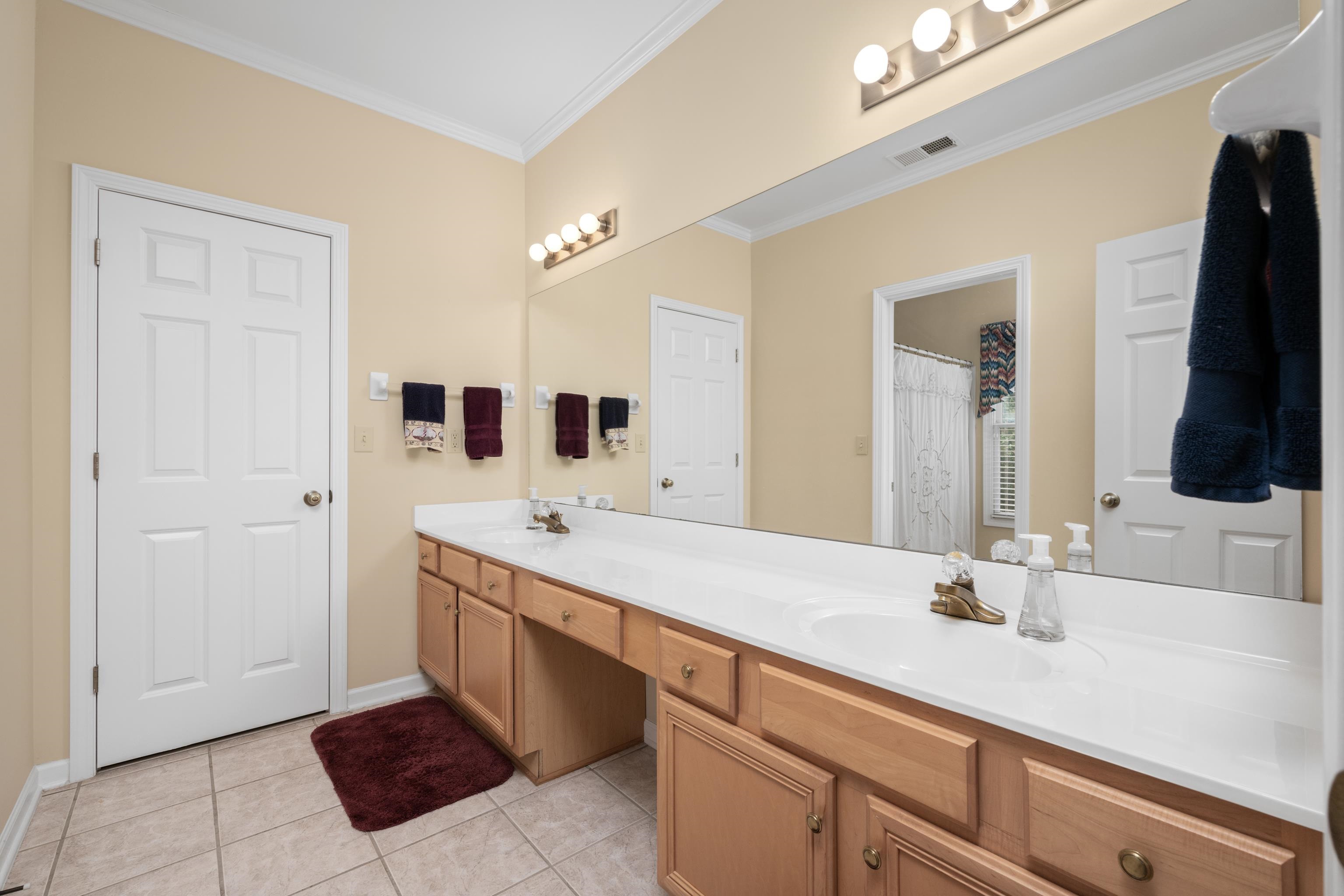 192 North White Station Road Memphis, TN 38117 - Photo 23 of 40 a spacious bathroom with a double vanity sink and mirror
