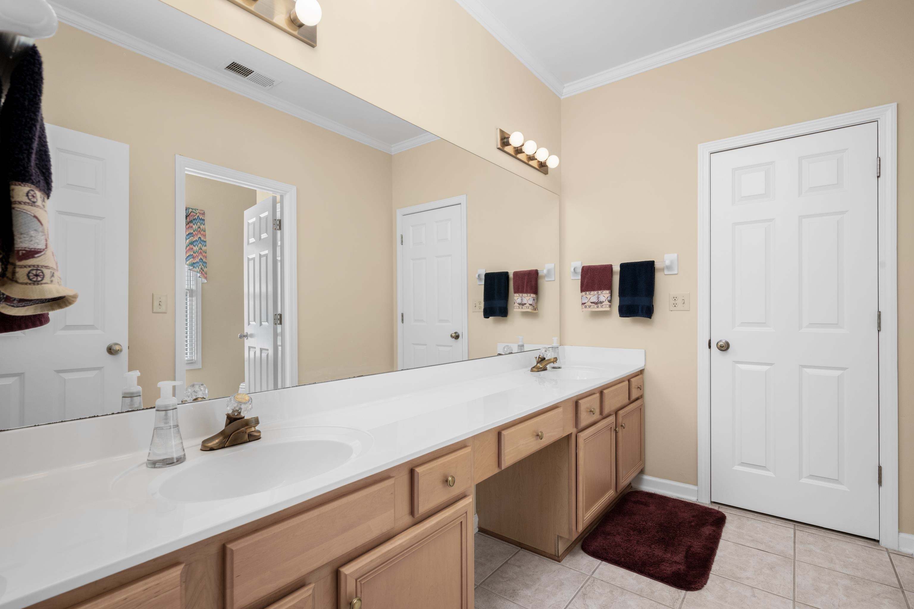 192 North White Station Road Memphis, TN 38117 - Photo 29 of 40 a bathroom with a double vanity sink and mirror
