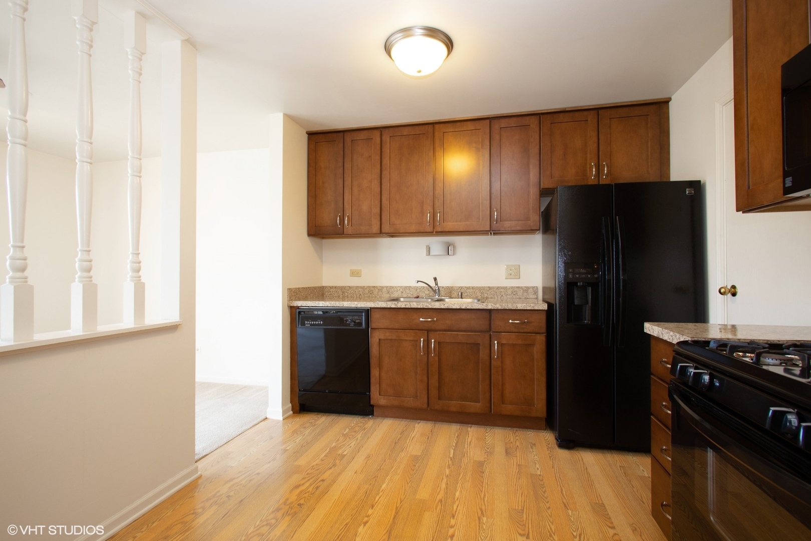 501 Cumberland Trail, Unit D Roselle, IL 60172 - Photo 4 of 10 a kitchen with granite countertop a refrigerator and a stove top oven