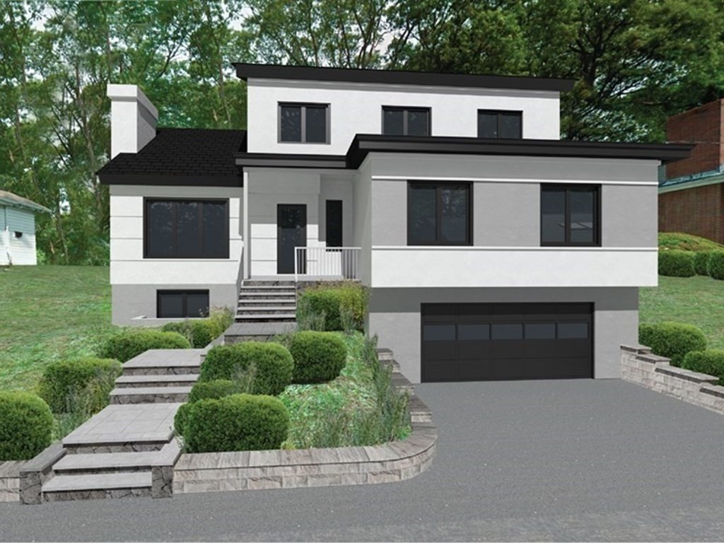 12 Bellingham Drive Brookline, MA 02467 - Photo 1 of 4 a front view of a house with a yard and garage