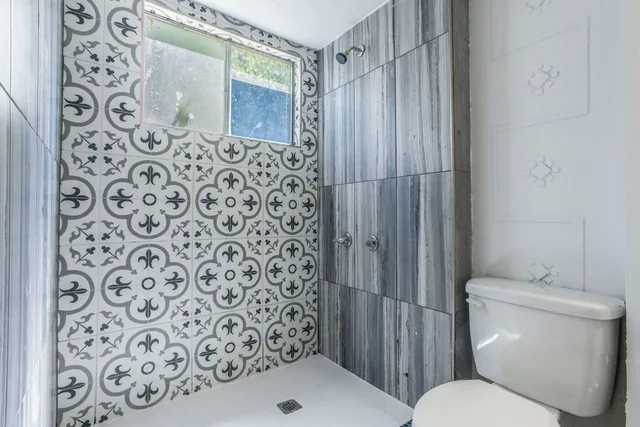 a bathroom with a toilet and a shower curtain