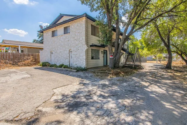 a view of a house with a yard covered in snow