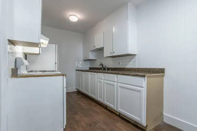 a kitchen with cabinets appliances and a counter top