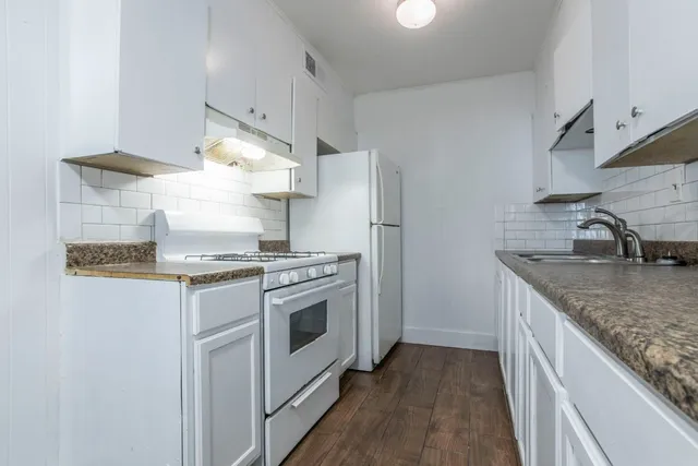 a kitchen with a stove and a sink